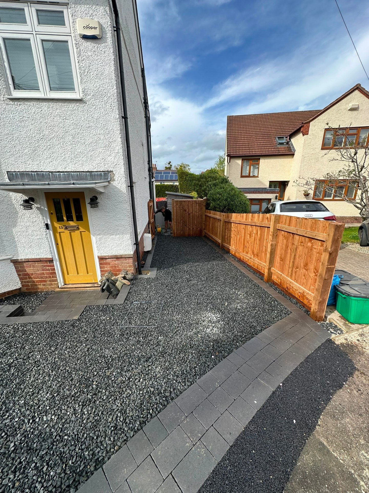 Dark grey decorative gravel driveway with block paving borders and new timber closeboard fencing.